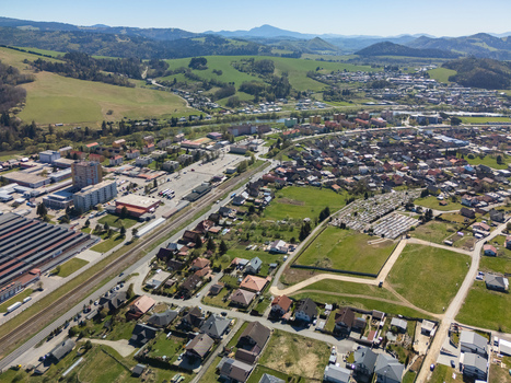 Aerial view of the town of Nizna with its residential neighborhoods industrial complexes and railway tracks set against rolling green hills Nizna Zilina Region Slovakia. Aerial view of the town of Nizna with its residential neighborhoods industrial complexes and railway tracks set against rolling green hills Nizna Zilina Region Slovakia.