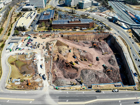 Reston United States 12 March 2019 Aerial view of a large construction site with excavators and earthmoving equipment operating within a deep excavation pit near urban roads. Reston United States 12 March 2019 Aerial view of a large construction site with excavators and earthmoving equipment operating within a deep excavation pit near urban roads.