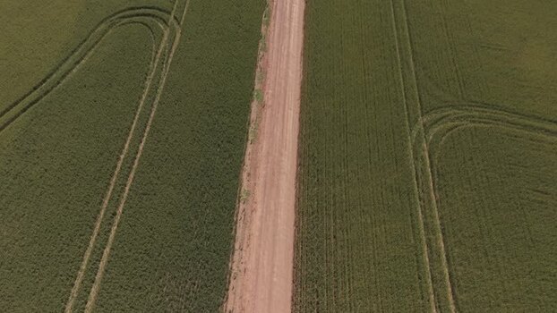 Aerial view of a dirt road through green fields South Africa. Aerial view of a dirt road through green fields South Africa.