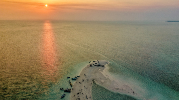 Aerial view of Pulau Gusung Sanggalau surrounded by turquoise waters and coral reefs in the Derawan Islands Kecamatan Pulau Derawan Kalimantan Timur Indonesia. Aerial view of Pulau Gusung Sanggalau surrounded by turquoise waters and coral reefs in the Derawan Islands Kecamatan Pulau Derawan Kalimantan Timur Indonesia.