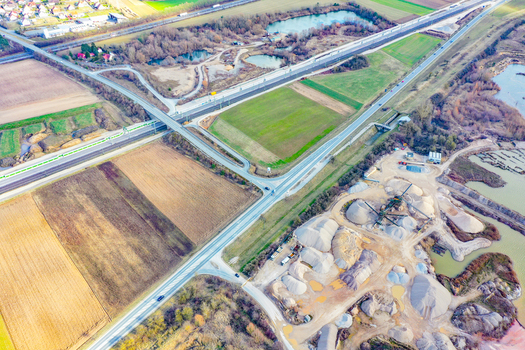 Aerial view of a gravel quarry with ponds next to a highway and agricultural fields in Buttenheim Bavaria Germany. Aerial view of a gravel quarry with ponds next to a highway and agricultural fields in Buttenheim Bavaria Germany.