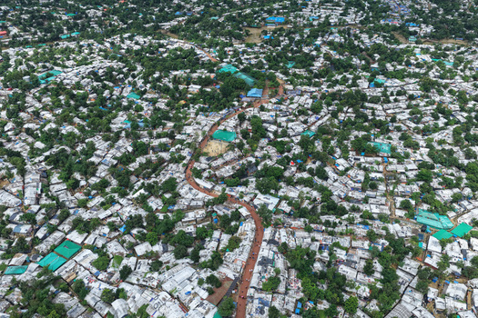 Aerial view of Camp 7 Kutupalang Expansion Sites featuring dense rows of makeshift shelters with white tarpaulin roofs in Cox s Bazar District Chittagong Division Bangladesh.