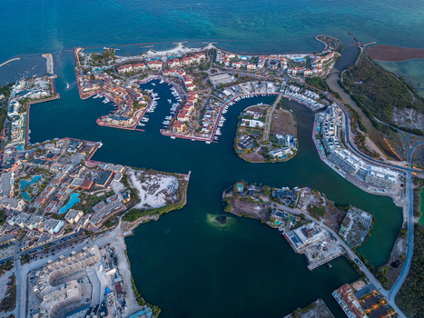 Aerial view of Marina Garden 2 Cap Cana featuring luxury waterfront residences a marina with docked boats and turquoise waters in Punta Cana La Altagracia Dominican Republic. Aerial view of Marina Garden 2 Cap Cana featuring luxury waterfront residences a marina with docked boats and turquoise waters in Punta Cana La Altagracia Dominican Republic.