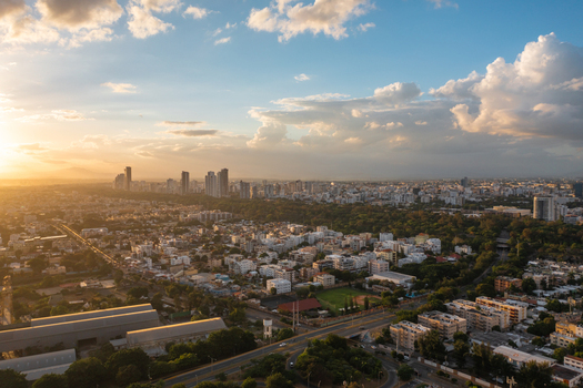Aerial view of Mirador Sur park and the urban landscape of Santo Domingo at sunset featuring high rise buildings and lush trees in Santo Domingo Distrito Nacional Dominican Republic. Aerial view of Mirador Sur park and the urban landscape of Santo Domingo at sunset featuring high rise buildings and lush trees in Santo Domingo Distrito Nacional Dominican Republic.