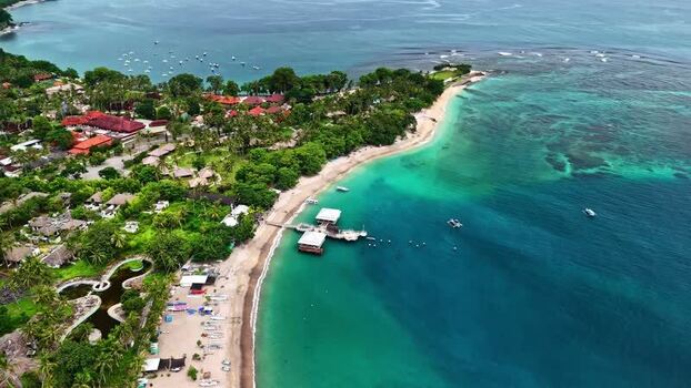 Aerial view of tropical coastline with pier in Bali Indonesia.