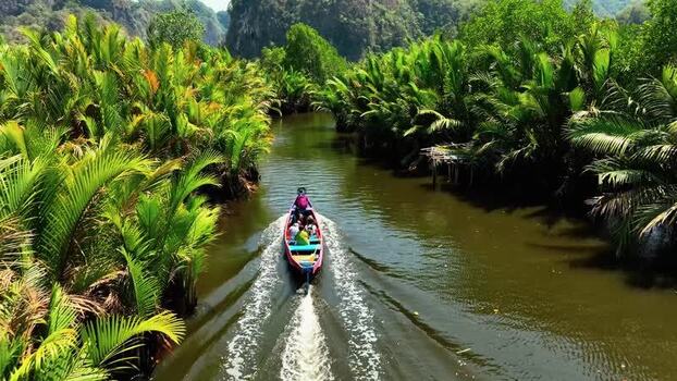Aerial view of a boat cruising through a tropical river in Maros Indonesia. Aerial view of a boat cruising through a tropical river in Maros Indonesia.