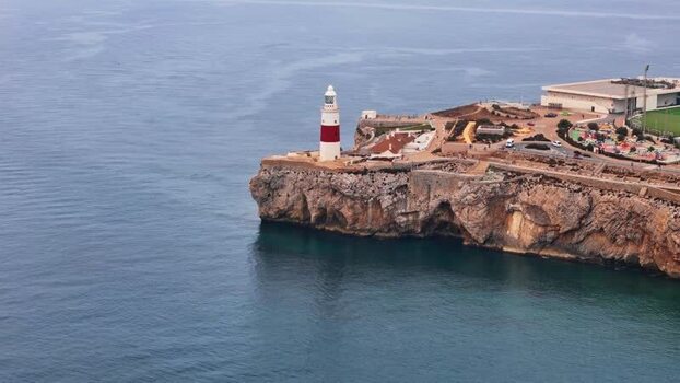 Aerial view of Europa Point lighthouse on rocky cliffs Gibraltar.