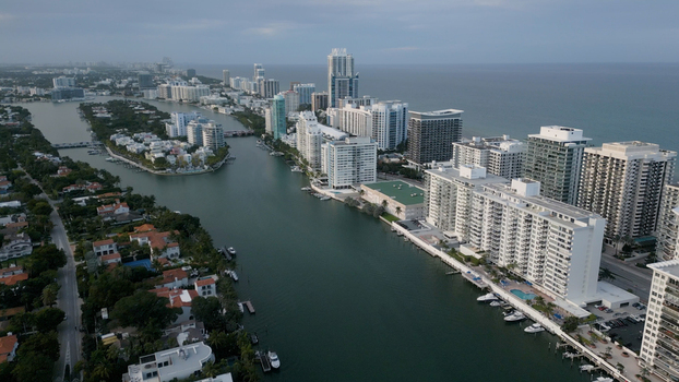 Aerial view of Miami Beach featuring the Intracoastal Waterway high rise buildings luxury waterfront properties and boats docked along the canal in Miami Beach Florida United States. Aerial view of Miami Beach featuring the Intracoastal Waterway high rise buildings luxury waterfront properties and boats docked along the canal in Miami Beach Florida United States.