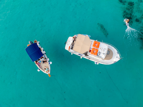 Aerial view of boats floating on the turquoise water near the Blue Lagoon their vibrant colors a stark contrast to the serene sea Blue lagoon Comino Malta. Aerial view of boats floating on the turquoise water near the Blue Lagoon their vibrant colors a stark contrast to the serene sea Blue lagoon Comino Malta.