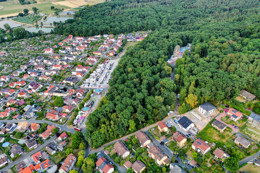Forchheim Germany 26 July 2025 Aerial view of the Annafest festival with a Ferris wheel nestled in the Kellerwald forest surrounded by residential houses and lush greenery. Forchheim Germany 26 July 2025 Aerial view of the Annafest festival with a Ferris wheel nestled in the Kellerwald forest surrounded by residential houses and lush greenery.