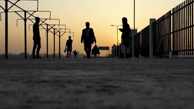View of silhouettes of people walking at sunset Bangladesh. View of silhouettes of people walking at sunset Bangladesh.