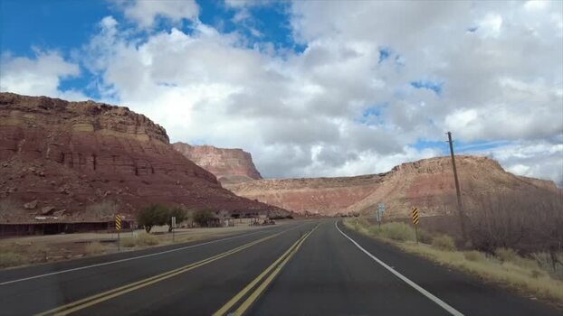 View of desert road and red rock formations United States. View of desert road and red rock formations United States.