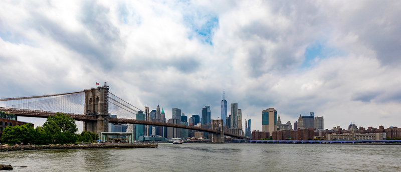 New York New York United States 08 July 2021 View of Brooklyn Bridge spanning the East River with the Manhattan skyline in the background under a cloudy sky. New York New York United States 08 July 2021 View of Brooklyn Bridge spanning the East River with the Manhattan skyline in the background under a cloudy sky.