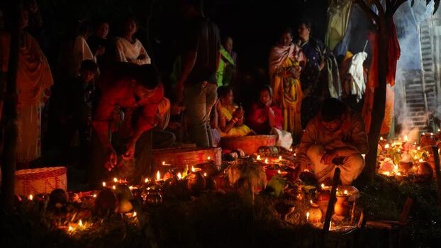View of people lighting oil lamps during a festival in Bangladesh. View of people lighting oil lamps during a festival in Bangladesh.