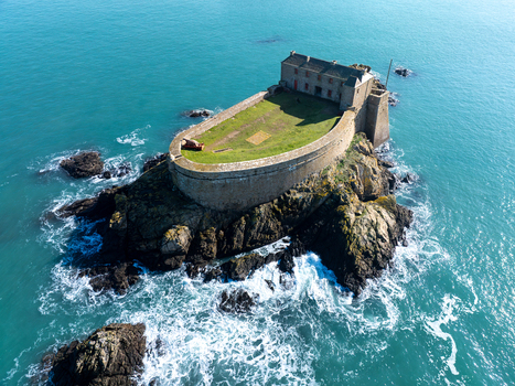 Aerial view of Fort du Petit Bé rises majestically from the sea its ancient stones contrasting with the vivid turquoise waters Saint Malo Bretagne France. Aerial view of Fort du Petit Bé rises majestically from the sea its ancient stones contrasting with the vivid turquoise waters Saint Malo Bretagne France.