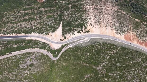Aerial view of a winding road in the hills of Albania.