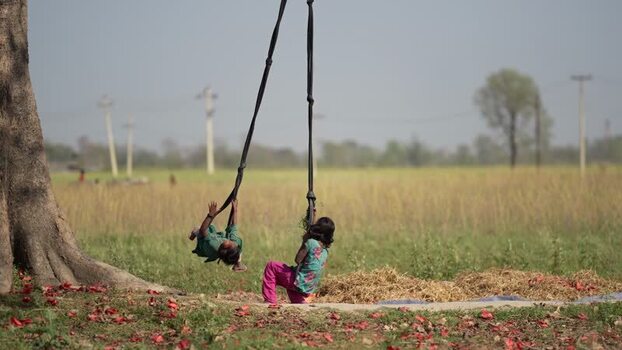 View of children playing on a rope swing in Dhangadhi Nepal.