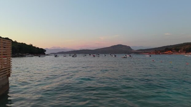 Aerial view of boats in a bay at sunset in Albania.