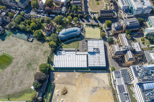 Aerial view of the Data Center at Oxford University featuring modern industrial buildings surrounding green spaces tennis courts and historic architecture in Oxford England United Kingdom. Aerial view of the Data Center at Oxford University featuring modern industrial buildings surrounding green spaces tennis courts and historic architecture in Oxford England United Kingdom.