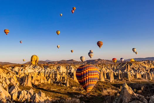 Goreme Nevsehir Turkiye 07 April 2025 Aerial view of hot air balloons floating over the unique fairy chimney rock formations of Cappadocia at sunrise. Goreme Nevsehir Turkiye 07 April 2025 Aerial view of hot air balloons floating over the unique fairy chimney rock formations of Cappadocia at sunrise.