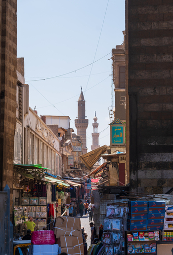 El Darb El Ahmar Egypt 20 April 2026 View of the Wikala of Al Ghouri complex and a bustling market street with people walking past shops and historic minarets in Cairo. El Darb El Ahmar Egypt 20 April 2026 View of the Wikala of Al Ghouri complex and a bustling market street with people walking past shops and historic minarets in Cairo.