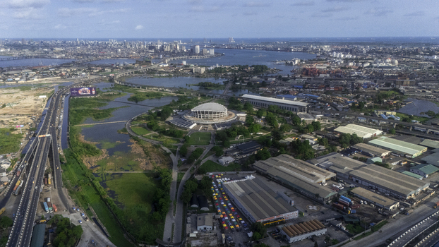 Aerial view of the Wole Soyinka Centre for Culture and Creative Arts National Theatre Nigeria with its iconic dome architecture and surrounding urban landscape in Lagos Lagos Nigeria. Aerial view of the Wole Soyinka Centre for Culture and Creative Arts National Theatre Nigeria with its iconic dome architecture and surrounding urban landscape in Lagos Lagos Nigeria.
