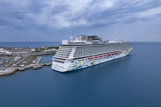 Royal Dockyard Bermuda 16 December 2022 Aerial view of the Norwegian Getaway cruise ship docked at the Royal Naval Dockyard surrounded by blue Atlantic waters. Royal Dockyard Bermuda 16 December 2022 Aerial view of the Norwegian Getaway cruise ship docked at the Royal Naval Dockyard surrounded by blue Atlantic waters.