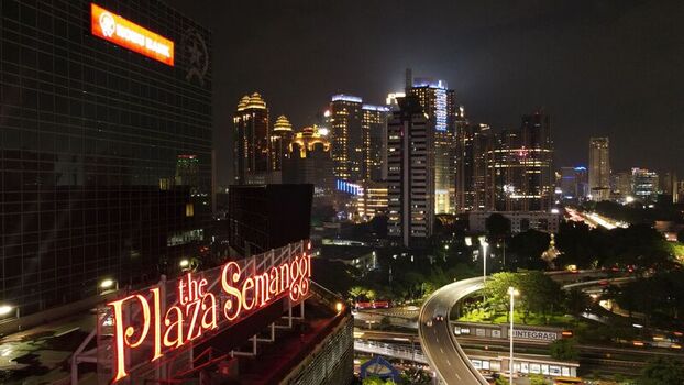 Kecamatan Setiabudi Indonesia 04 December 2021 Aerial view of Plaza Semanggi at night with illuminated signage skyscrapers and traffic on the elevated highway. Kecamatan Setiabudi Indonesia 04 December 2021 Aerial view of Plaza Semanggi at night with illuminated signage skyscrapers and traffic on the elevated highway.