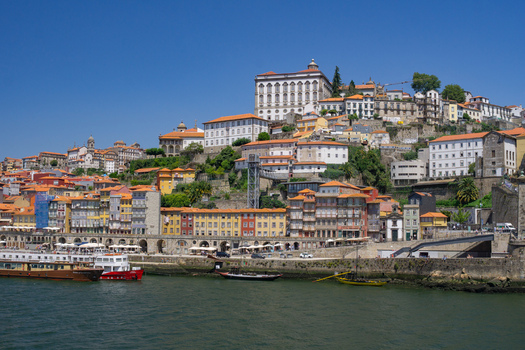 Aerial view of the vibrant Ribeira district cascading towards the Douro River under a clear sky Porto Porto District Portugal. Aerial view of the vibrant Ribeira district cascading towards the Douro River under a clear sky Porto Porto District Portugal.