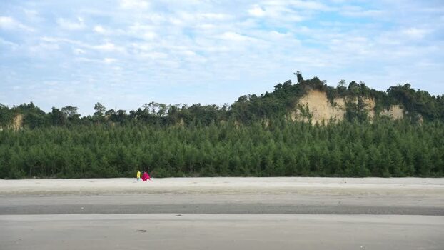 View of people walking on the beach in Cox s Bazar Bangladesh.