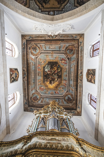 View of the ornate pipe organ and religious frescoed ceiling inside a historic church in Polignano a Mare Apulia Italy.