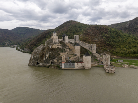 Aerial view of Golubac Fortress situated on the rocky banks of the Danube River with historic stone towers and walls in Golubac Branicevski okrug Serbia. Aerial view of Golubac Fortress situated on the rocky banks of the Danube River with historic stone towers and walls in Golubac Branicevski okrug Serbia.