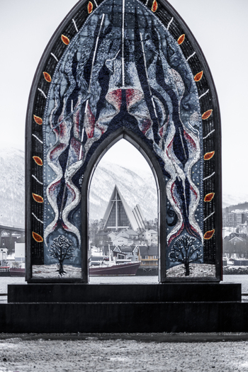 View of the Arctic Cathedral framed by a decorative mosaic archway in a snowy winter landscape in Tromso Troms Norway. View of the Arctic Cathedral framed by a decorative mosaic archway in a snowy winter landscape in Tromso Troms Norway.