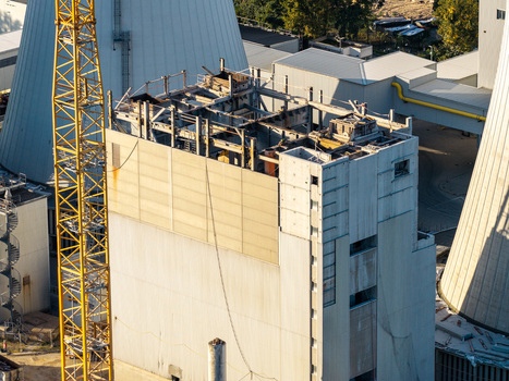 Aerial view of the deconstruction of the Combined Heat and Power Plant Lichterfelde featuring industrial structures cooling towers and a yellow construction crane in Berlin Berlin Germany. Aerial view of the deconstruction of the Combined Heat and Power Plant Lichterfelde featuring industrial structures cooling towers and a yellow construction crane in Berlin Berlin Germany.