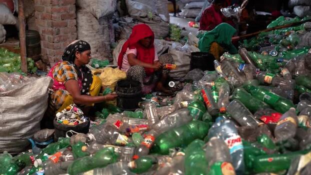 View of women sorting plastic bottles for recycling Bangladesh. View of women sorting plastic bottles for recycling Bangladesh.