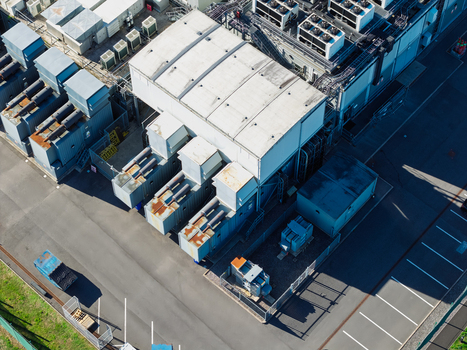 Aerial view of a data center facility with cooling units industrial equipment and parking spaces in the United Kingdom.