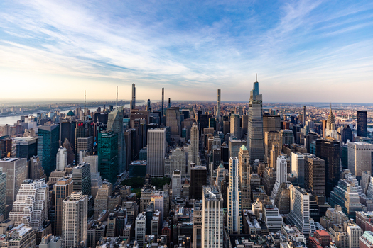 New York United States 09 August 2021 Aerial view of the dense Manhattan skyline featuring iconic skyscrapers glass towers and historic architecture under a clear blue sky.