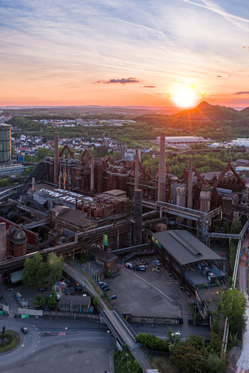 Volklingen Germany 09 May 2026 Aerial view of the Volklingen Ironworks industrial complex with its rusty pipes and tall chimneys under a golden sunset sky. Volklingen Germany 09 May 2026 Aerial view of the Volklingen Ironworks industrial complex with its rusty pipes and tall chimneys under a golden sunset sky.