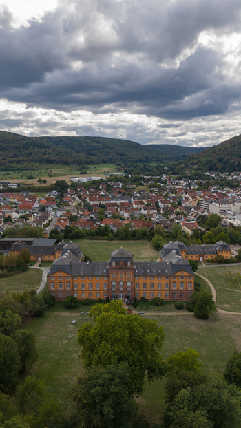 Aerial view of Chateauform Schloss Lowenstein surrounded by parkland and the town Kleinheubach Bayern Germany. Aerial view of Chateauform Schloss Lowenstein surrounded by parkland and the town Kleinheubach Bayern Germany.