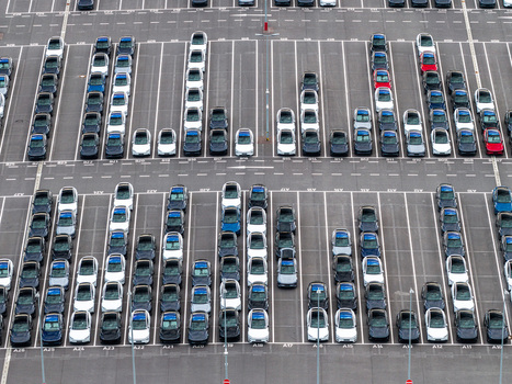 Aerial view of Tesla Gigafactory Berlin Brandenburg showing rows of new electric cars parked in a large asphalt lot. Grunheide Mark Brandenburg Germany. Aerial view of Tesla Gigafactory Berlin Brandenburg showing rows of new electric cars parked in a large asphalt lot. Grunheide Mark Brandenburg Germany.