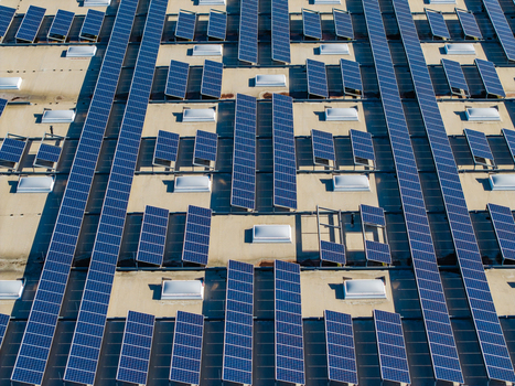 Aerial view of the Logistikzentrum Allhaming featuring rows of solar panels and skylights on the industrial roof in Allhaming Oberosterreich Austria. Aerial view of the Logistikzentrum Allhaming featuring rows of solar panels and skylights on the industrial roof in Allhaming Oberosterreich Austria.