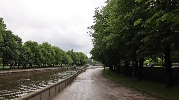 View of the riverbank and tree lined path in Kaliningrad Russia.