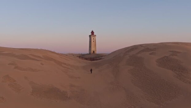 Aerial view of Rubjerg Knude lighthouse in sand dunes Denmark.
