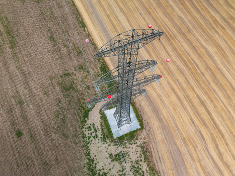 Aerial view of power lines crossing farmland near Ercsi Hungary in summer Aerial view of power lines crossing farmland near Ercsi Hungary in summer