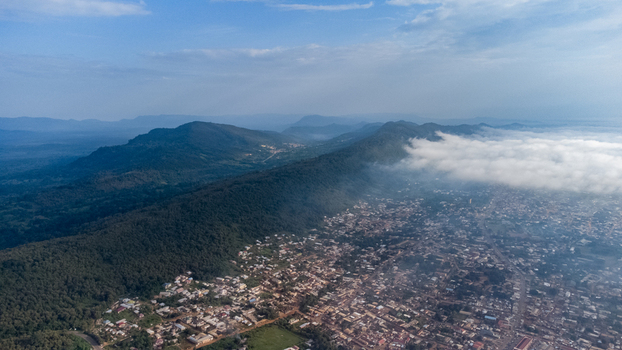 Aerial view of the city of Ho nestled against the lush green mountains of the Volta Region Ho Volta Region Ghana. Aerial view of the city of Ho nestled against the lush green mountains of the Volta Region Ho Volta Region Ghana.