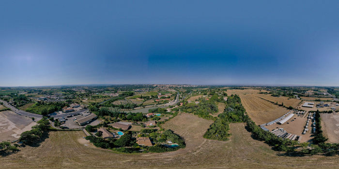 Aerial view of Les 9 Ecluses de Fonseranes on the Canal du Midi surrounded by lush greenery and rural landscapes in Beziers Occitanie France.