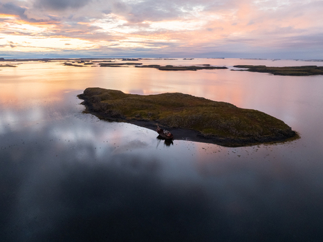 Aerial view of a mysterious islet reflecting the pastel sky with the submerged shipwreck adding a somber note Snæfellsnes Eyja og Miklaholtshreppur Iceland. Aerial view of a mysterious islet reflecting the pastel sky with the submerged shipwreck adding a somber note Snæfellsnes Eyja og Miklaholtshreppur Iceland.
