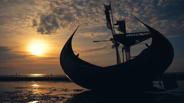 View of a traditional moon boat silhouette on the beach Bangladesh. View of a traditional moon boat silhouette on the beach Bangladesh.