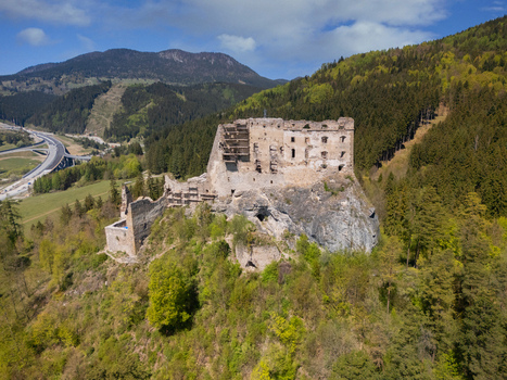 Aerial view of Castle Likava ruins perched on a rocky outcrop surrounded by lush green forests and rolling mountains in Likavka Zilina Region Slovakia. Aerial view of Castle Likava ruins perched on a rocky outcrop surrounded by lush green forests and rolling mountains in Likavka Zilina Region Slovakia.