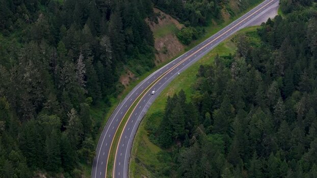 Aerial view of a winding highway through a forest United States. Aerial view of a winding highway through a forest United States.
